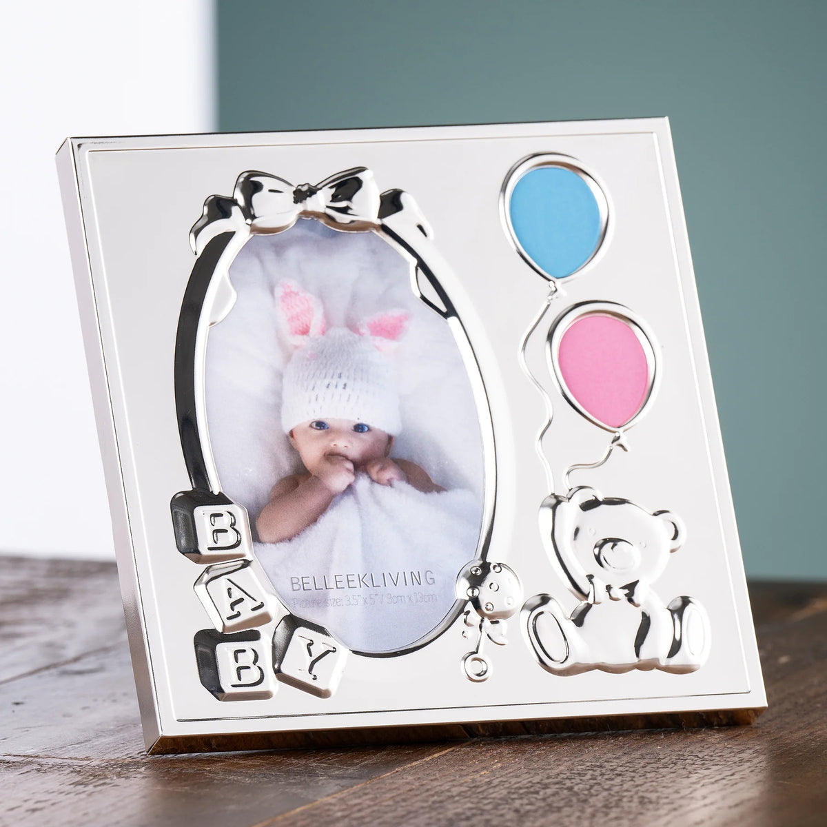 Silver baby photo frame with balloon and teddy bear decorations, and blocks spelling "BABY
