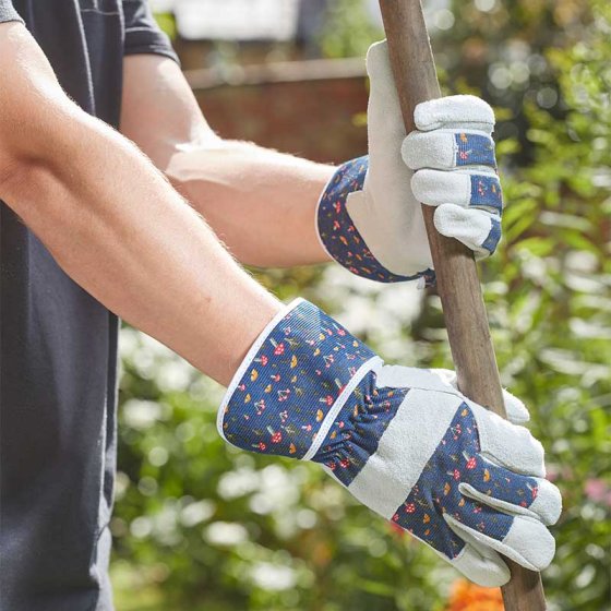 Hands wearing Mushrooms Premium Lightweight Rigger M8 gloves gripping a wooden stick outdoors