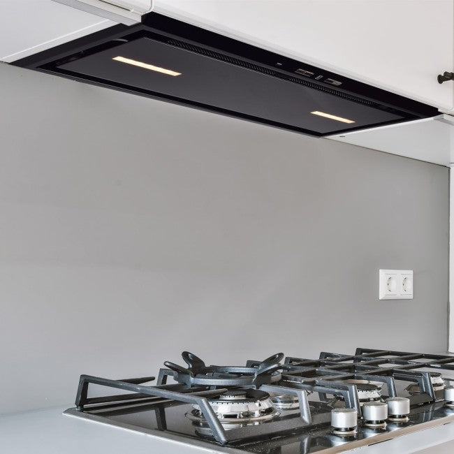 Black glass Luxair 86cm canopy cooker hood installed under white kitchen cabinets above a gas stove.