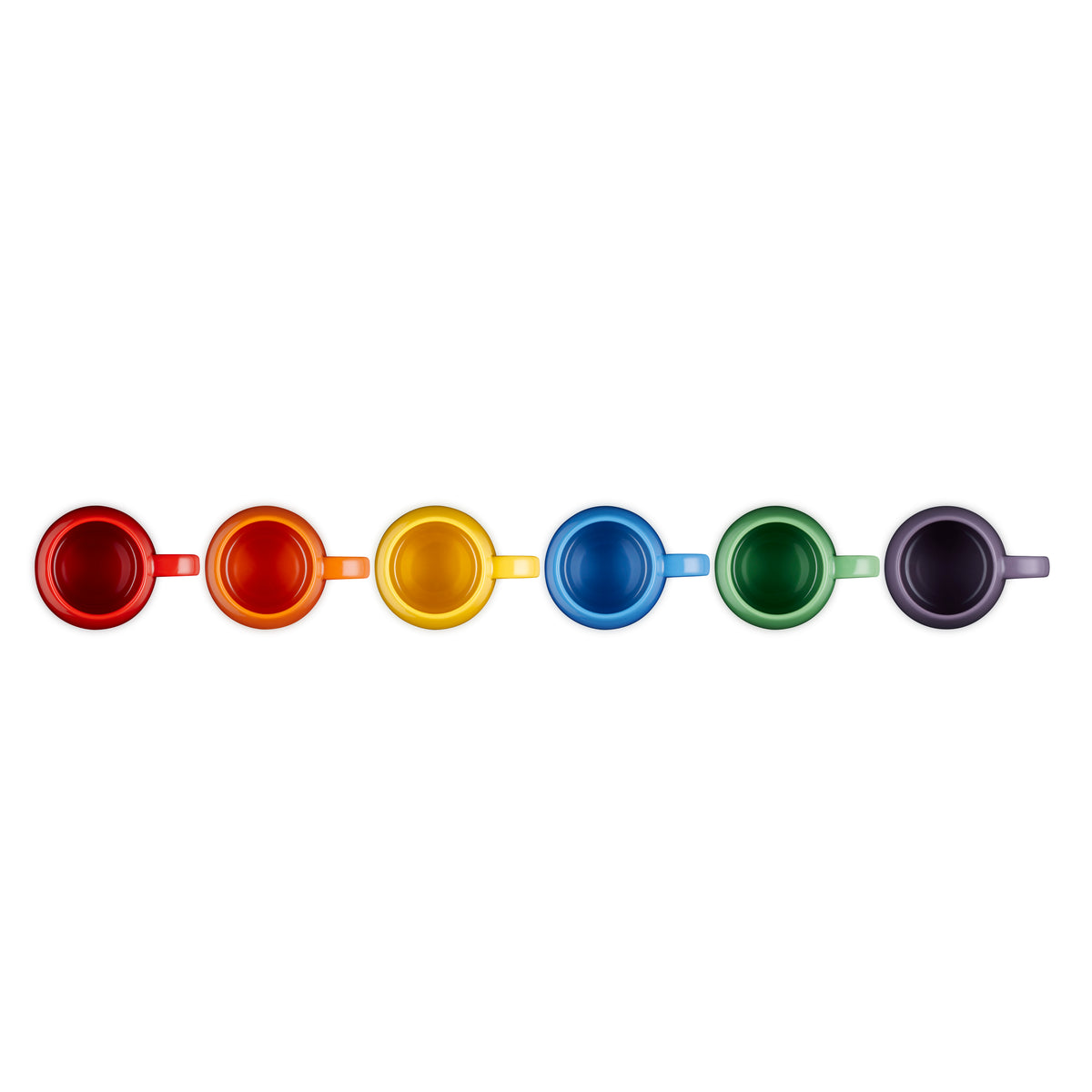 Top view of six Le Creuset Rainbow coupe mugs in red, orange, yellow, blue, green, and purple lined up horizontally.