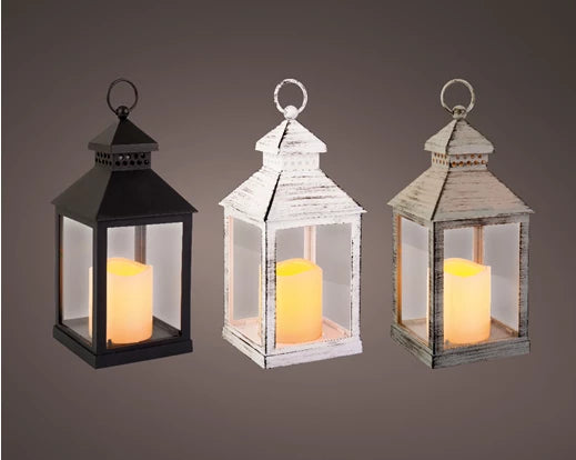 Three square LED lanterns with battery-operated candles, in black, white distressed, and gray distressed finishes.