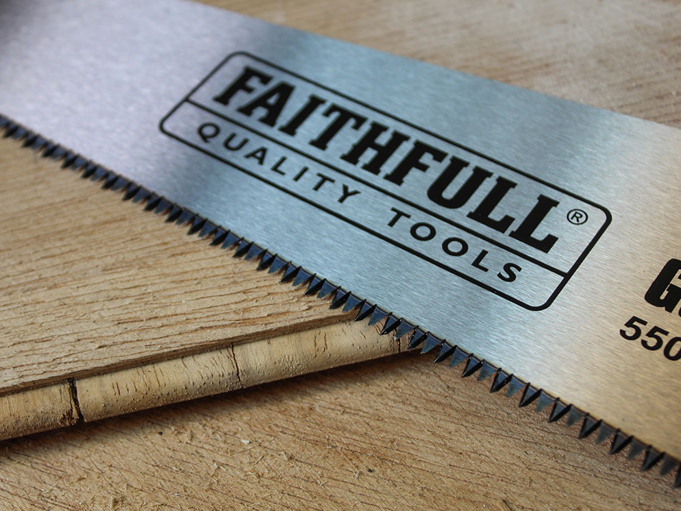 Close-up of the Faithfull General-Purpose Hardpoint Handsaw blade showing sharp teeth and logo on wood surface.