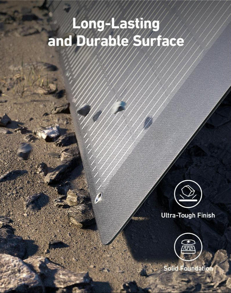Close-up of Anker 531 Solar Panel corner showing durable surface with rocks on the ground beneath.