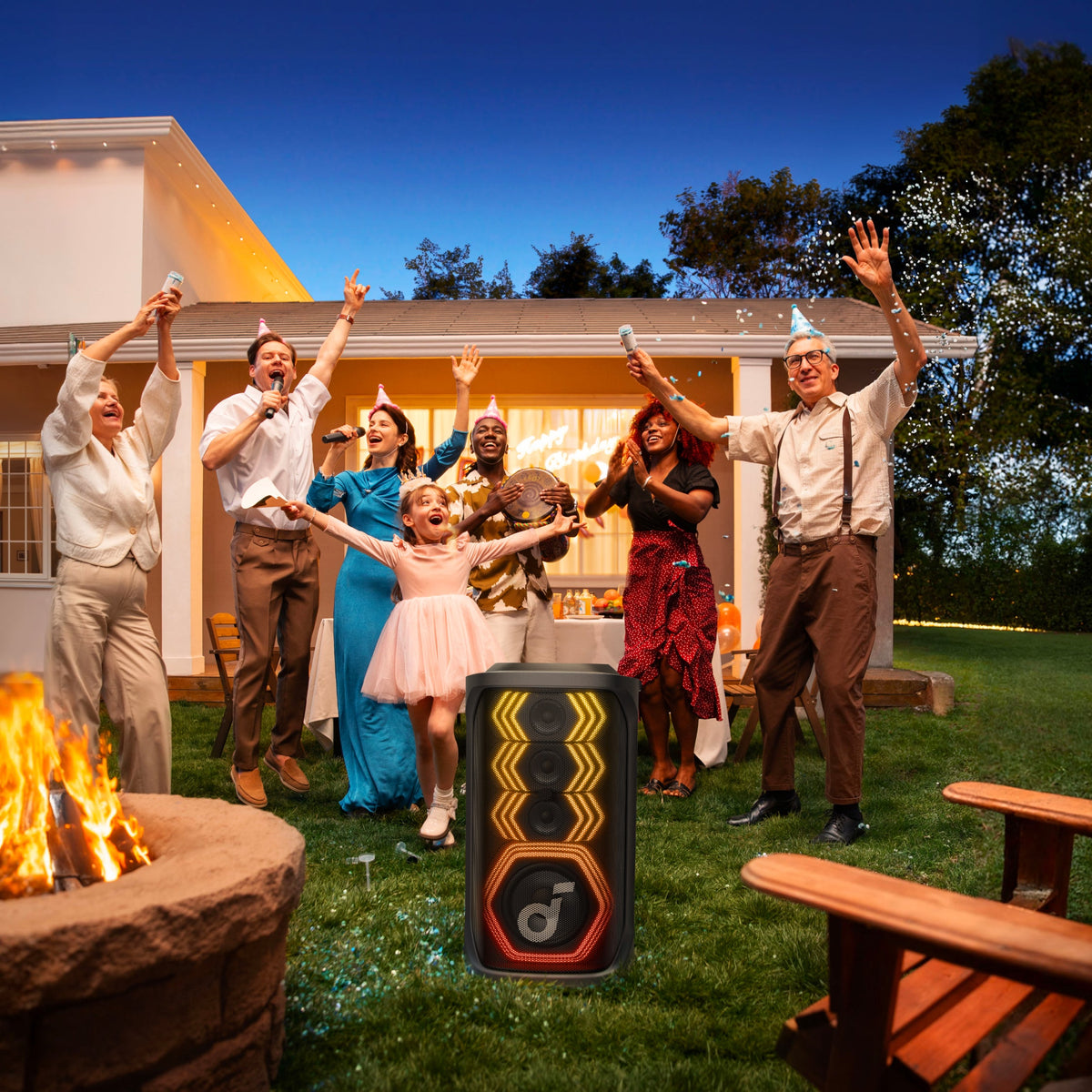 Soundcore Rave 3s Black speaker with colorful LED lights at an outdoor party with people celebrating.