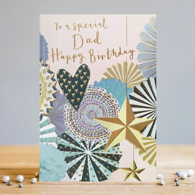 Dad birthday card with gold foil text and decorative stars and hearts on textured cardstock.