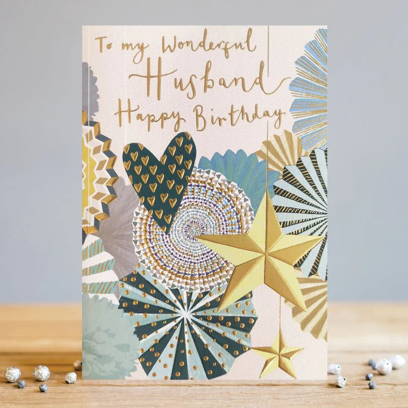 LT Husband Happy Birthday card with gold foil stars, hearts, and geometric patterns on textured cream card.