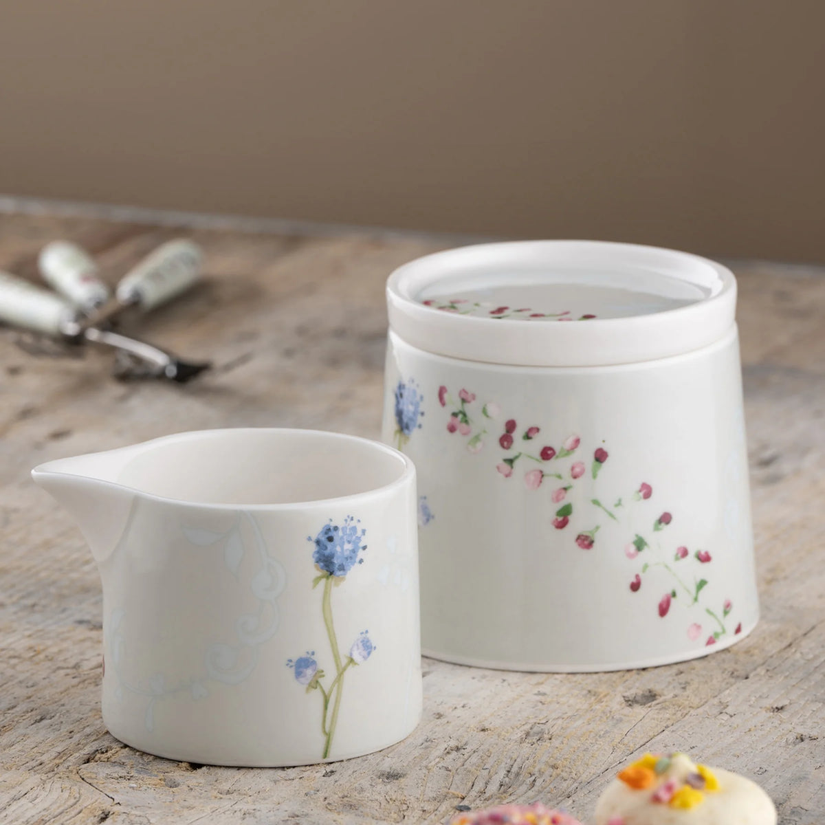 Camille Pale Jade Sugar & Cream set with floral patterns on a rustic wooden surface