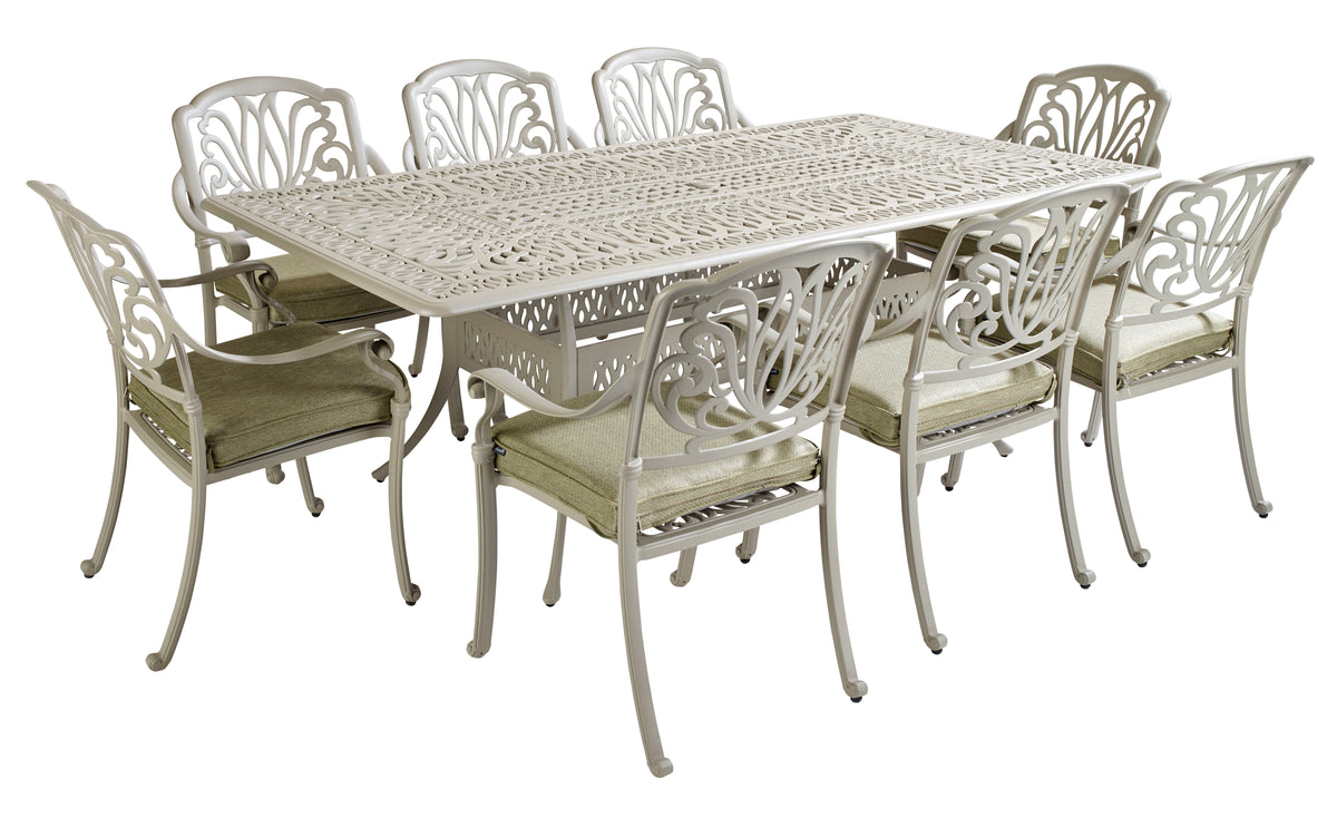 Rectangular Amalfi 8-seat dining table with ornate maize metal top and wheatgrass cushioned chairs.