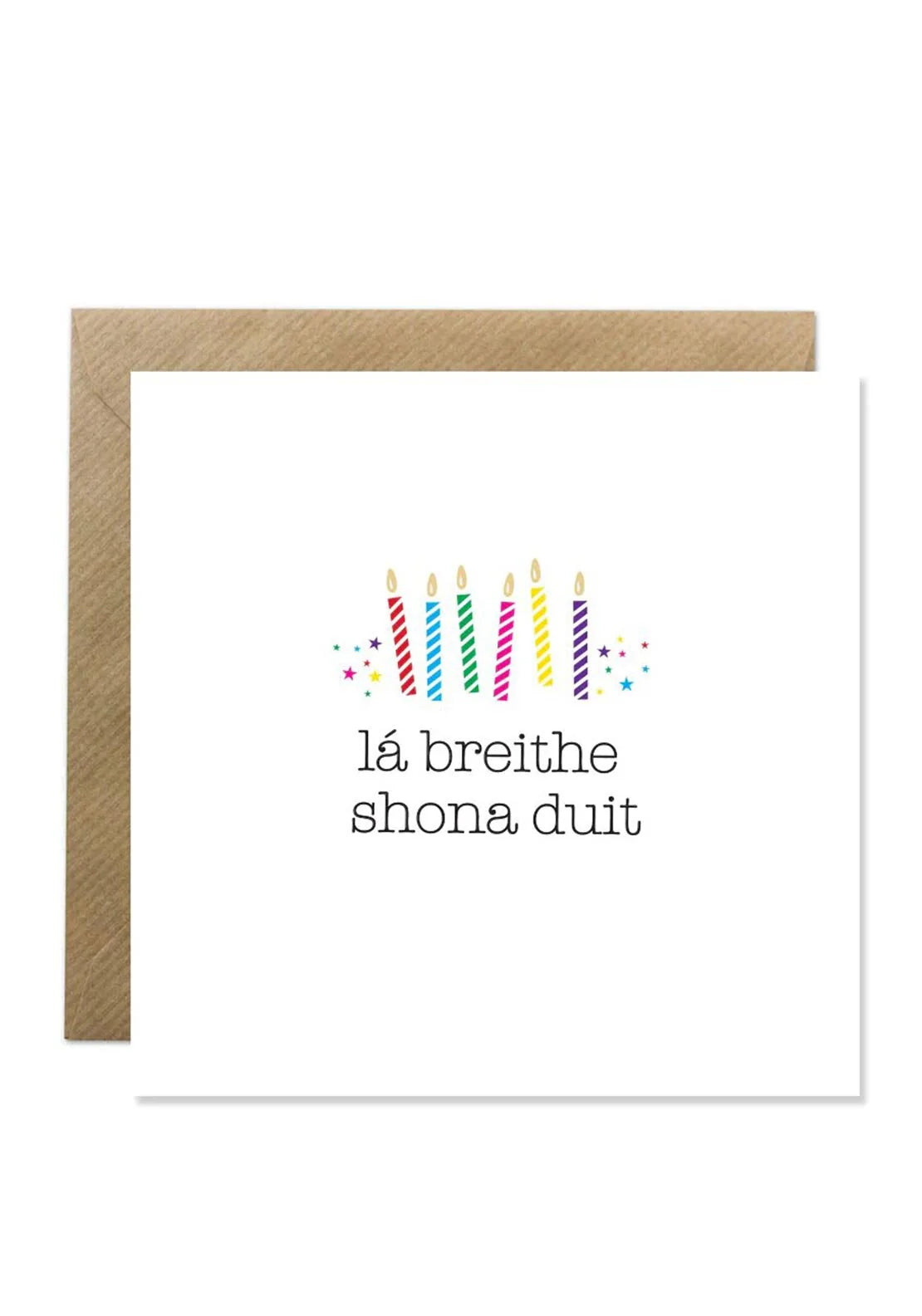 Cream Irish birthday card with six colorful striped candles and "lá breithe shona duit" text, with brown envelope.
