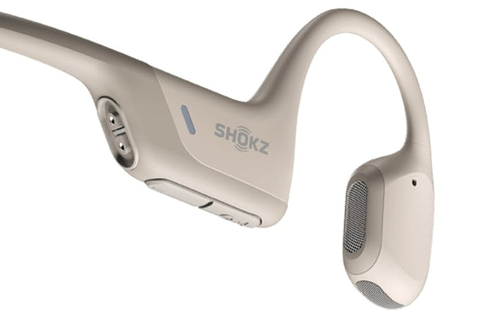 Shokz Openrun Pro Mini Beige Open-Ear Sport Earbuds, lightweight and wireless, available at Keans Claremorris