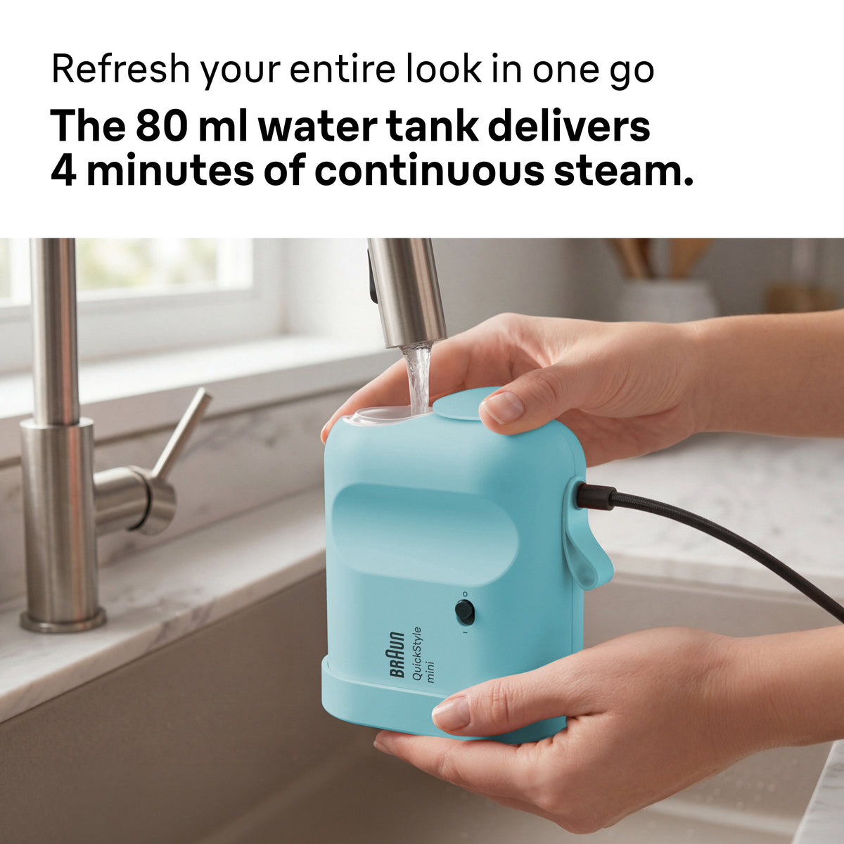 Hands filling a blue Braun Carestyle Mini Travel Garment Steamer with water at a kitchen sink.