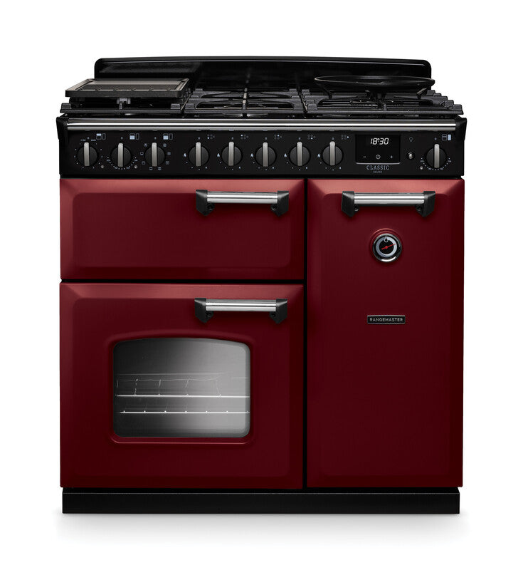 Rangemaster Classic Deluxe 90cm chrome dual fuel rangecooker in burgundy with multiple ovens and control knobs