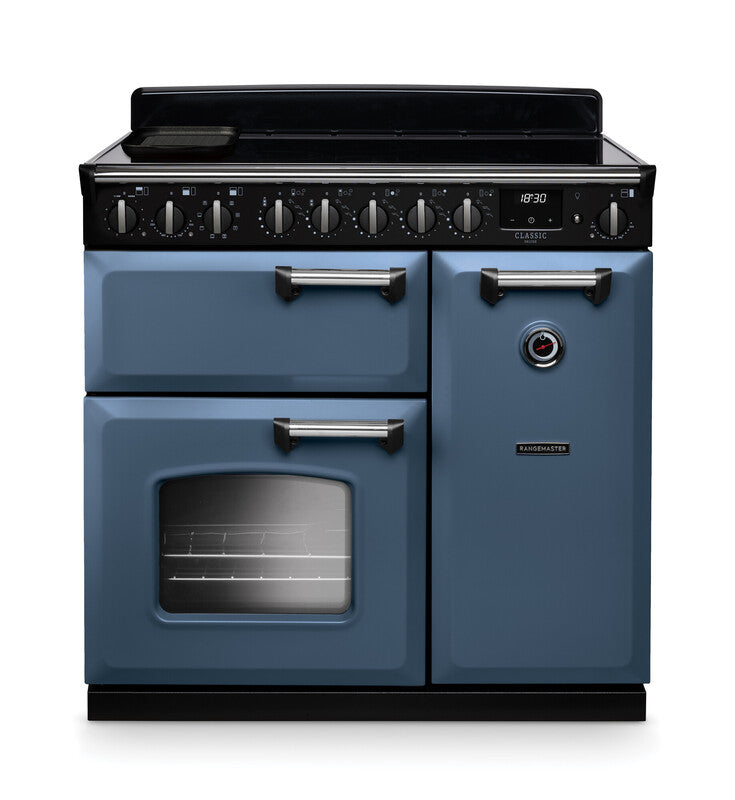 Rangemaster Classic Deluxe 90cm blue induction rangecooker with multiple ovens and control knobs on black panel