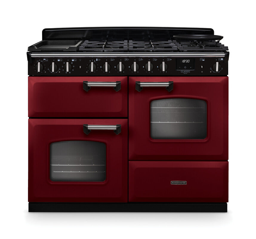 Rangemaster Classic Deluxe 110 dual fuel cooker in burgundy with chrome handles and black control panel