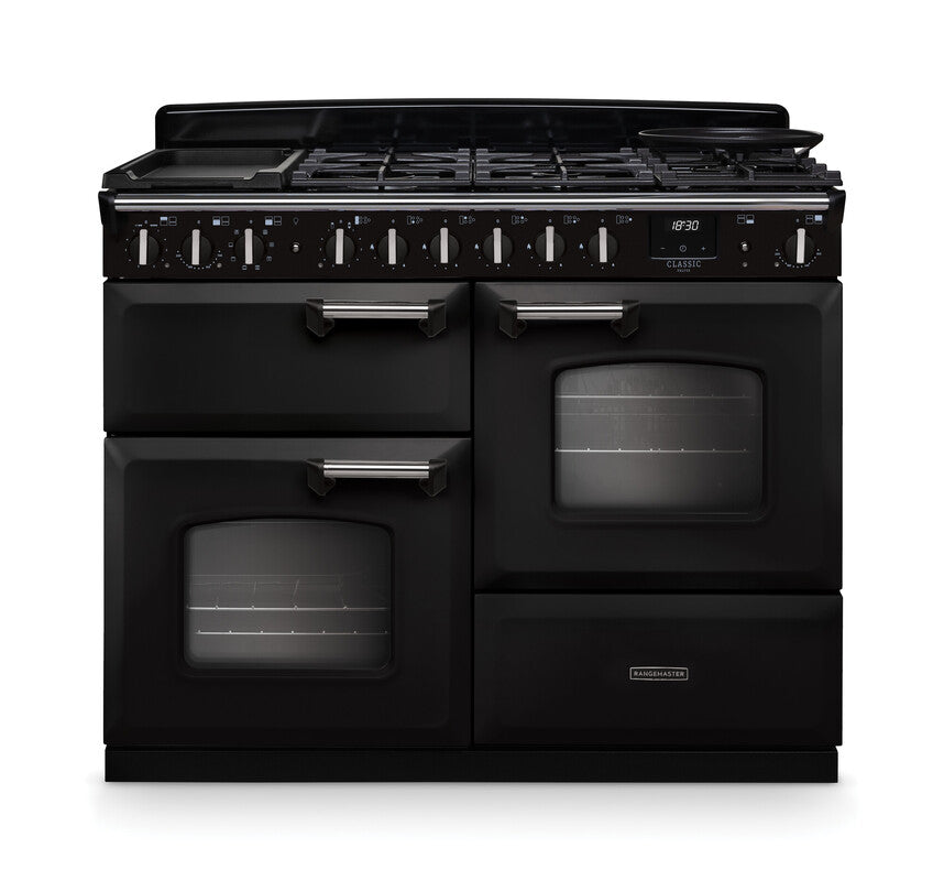 Rangemaster Classic Deluxe 110 dual fuel cooker in black with chrome trim, six burners, and two ovens visible front view.