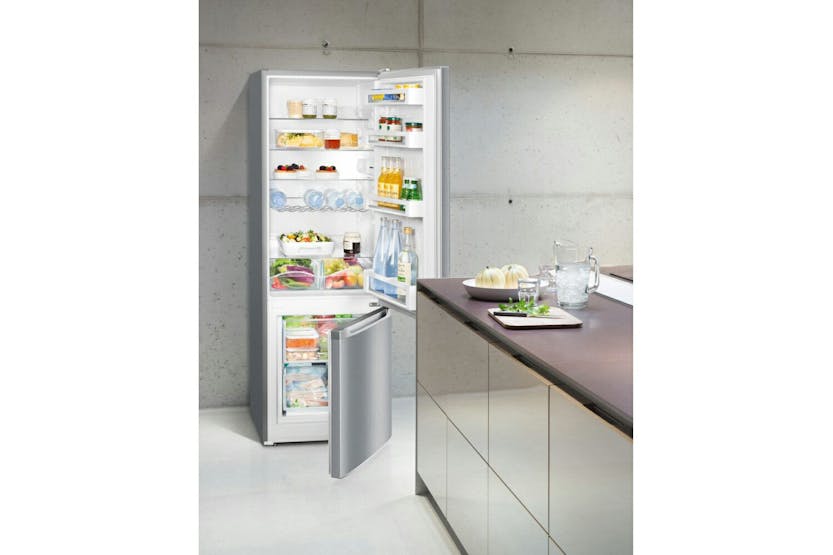 Liebherr freestanding fridge freezer with open fridge and freezer doors showing stocked shelves in a modern kitchen.