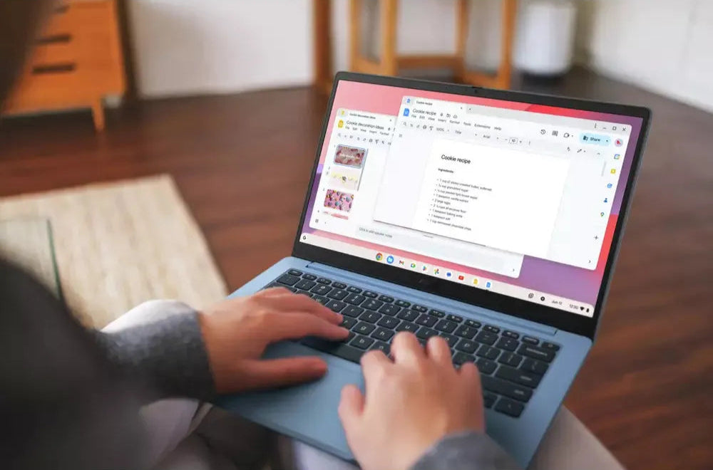 Hands typing on a grey Asus 14" HD Chromebook showing a cookie recipe on screen