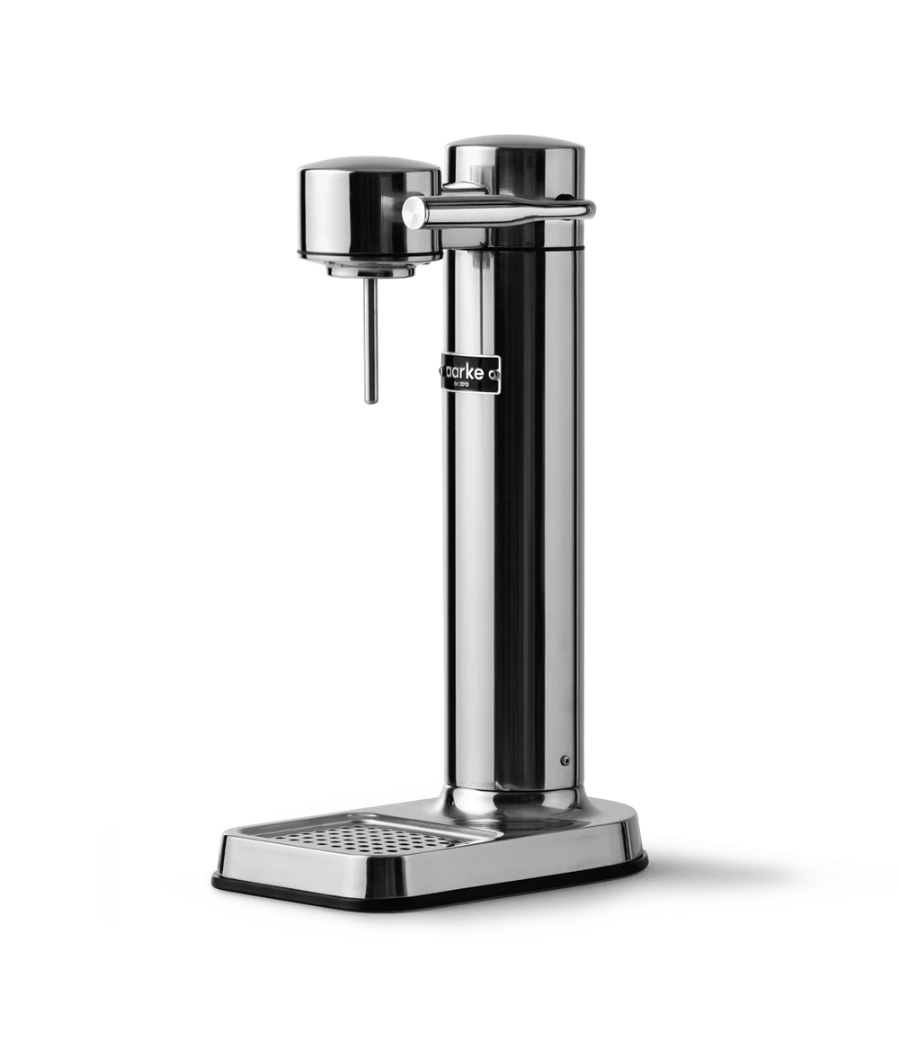 Aarke Carbonator 3 steel soda maker with a sleek cylindrical design and drip tray on a white background