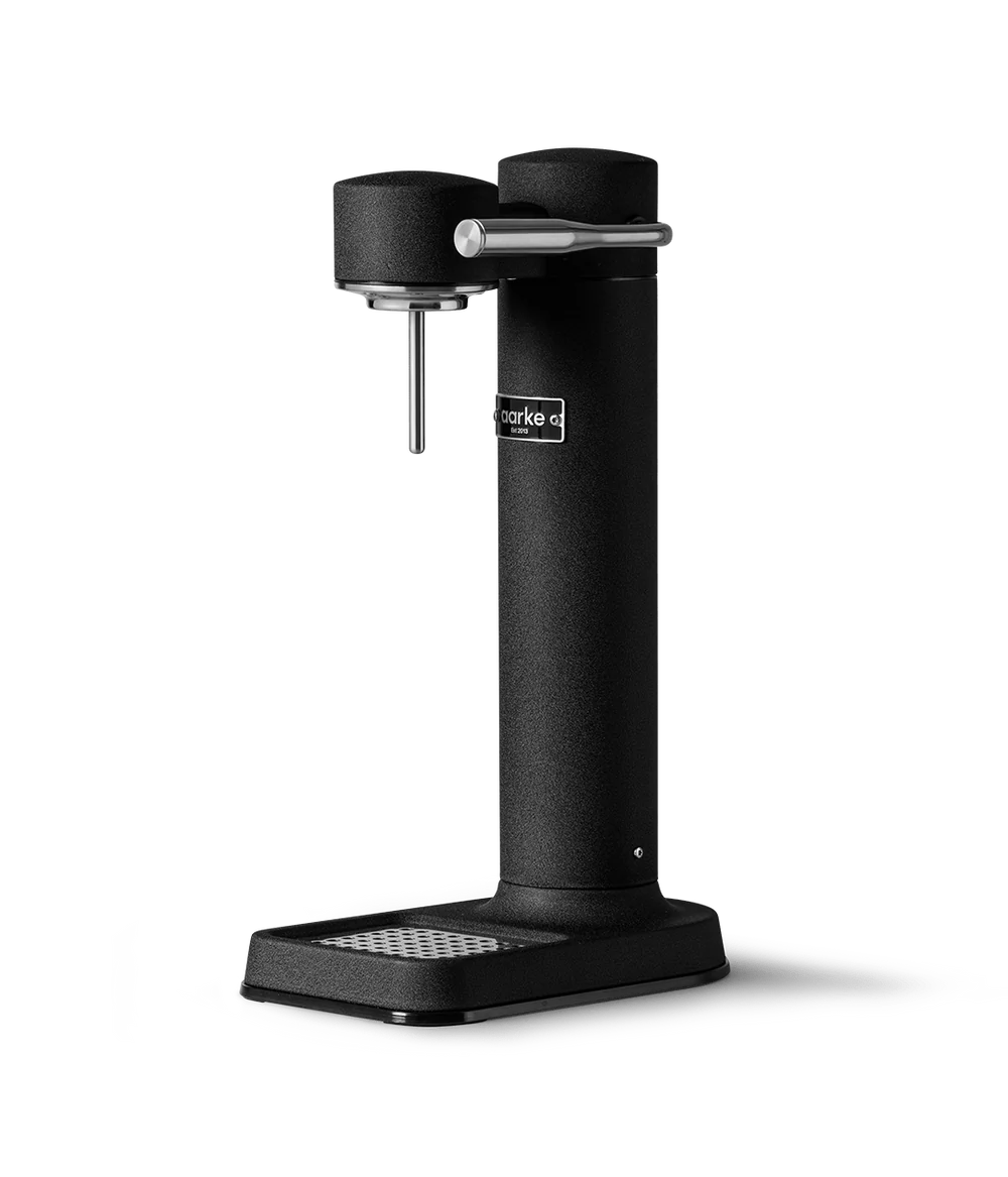 Aarke Carbonator 3 matte black soda maker with stainless steel lever and drip tray on white background