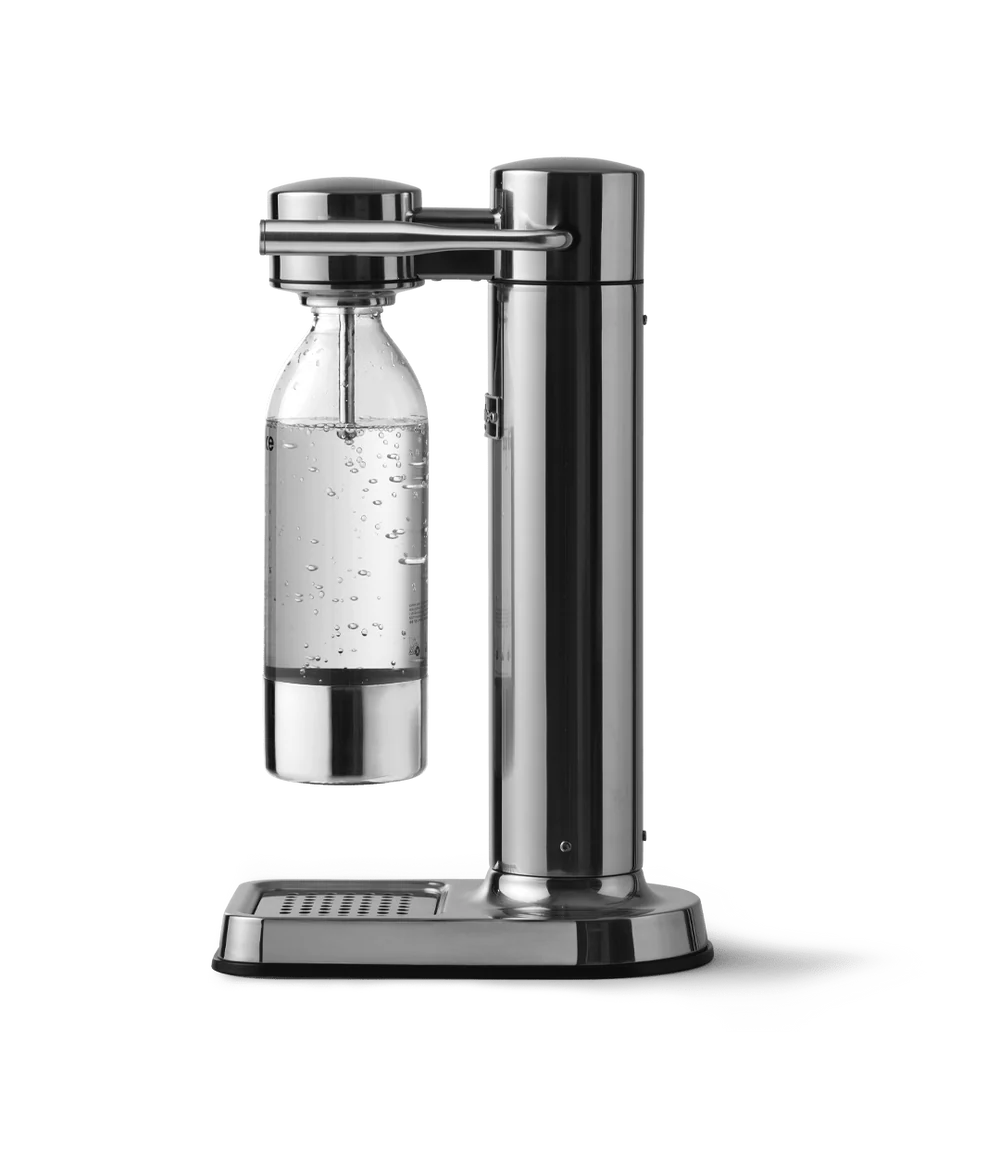 Aarke Carbonator 3 steel soda maker with a clear bottle filled with sparkling water on a white background