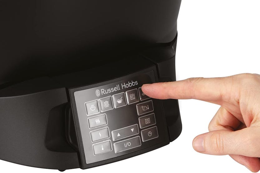 Finger pressing a button on the digital control panel of the Russel Hobbs Slow Cooker 8 in 1.
