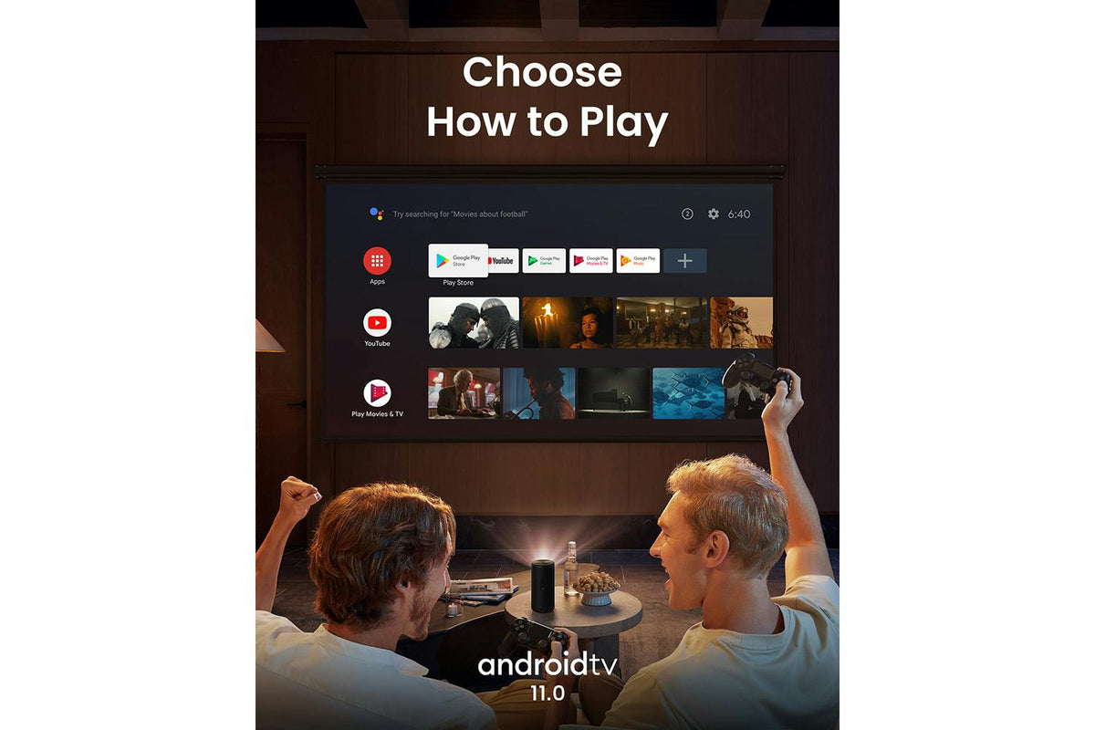 Nebula Capsule 3 projector on a table projecting Android TV interface while two people play games with controllers