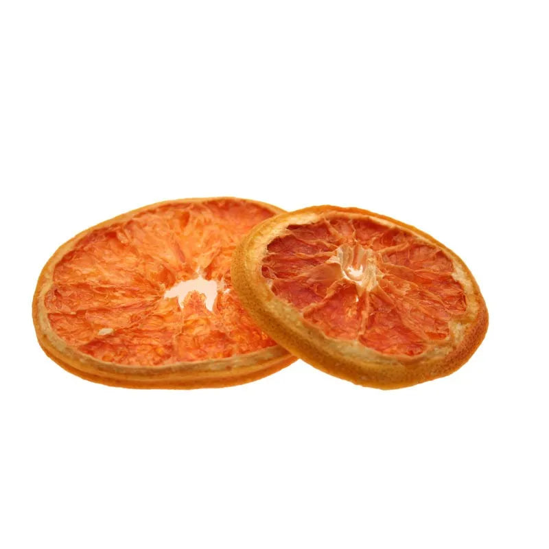 Two natural dried grapefruit slices with bright orange color and rustic edges on white background