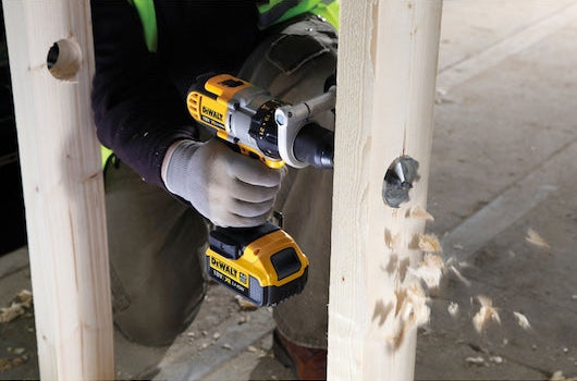 DeWalt Self-Feed Drill Bit 45mm attached to a drill, creating a clean hole in a wooden beam.