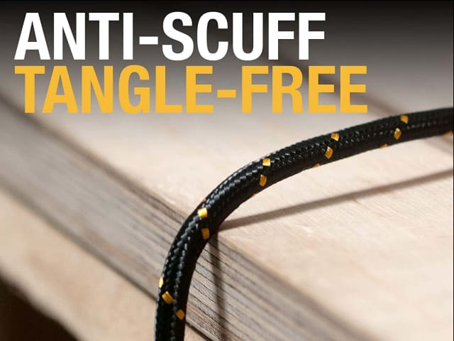 Close-up of black and yellow reinforced USB A to USB C charging cable on wooden surface with anti-scuff text.