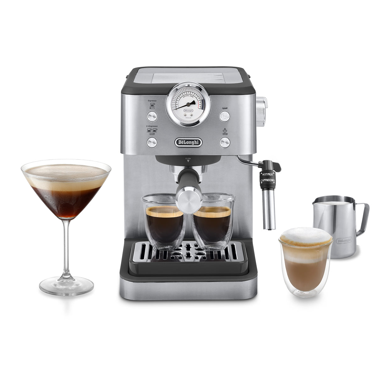 A silver and black De'Longhi espresso machine centered on a white background, with two espresso cups brewing underneath, a filled martini glass on the left, and a stainless steel milk pitcher and cup of latte on the right.