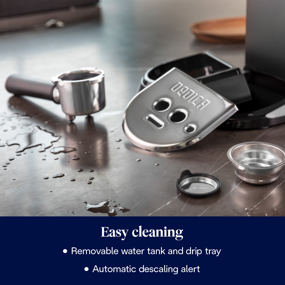Parts of the Delonghi Dedica Pump Coffee Machine bundle including removable drip tray and portafilter on a wet countertop.