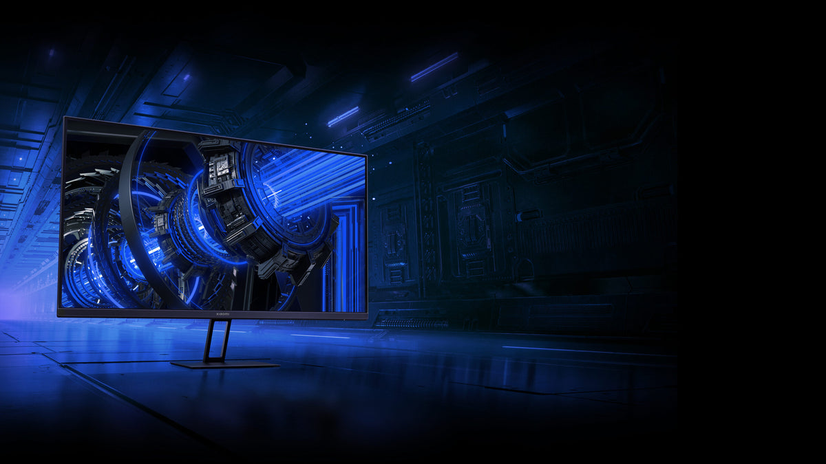 Xiaomi G27i 27" gaming monitor with thin bezels, futuristic blue sci-fi design on screen, and slim stand.