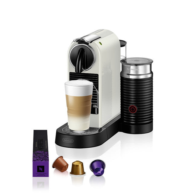 White DeLonghi Citiz Nespresso machine with Aeroccino frother, latte in glass, and three coffee capsules.