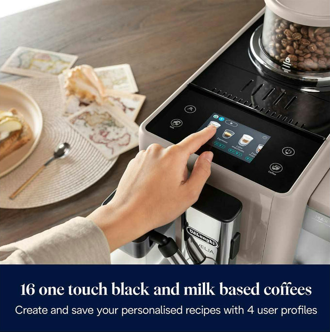 Hand pressing a coffee machine's touch screen with a plate of food and coffee beans in the background.