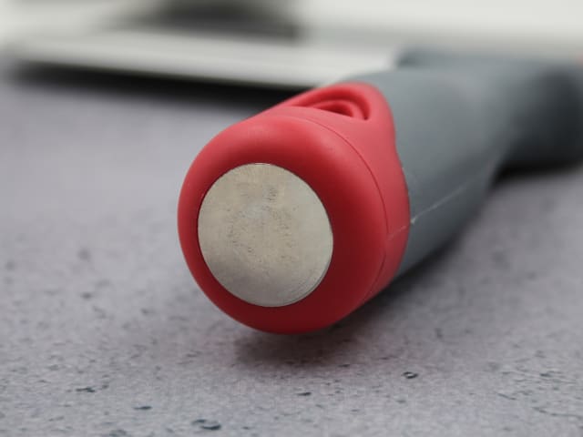 Close-up of the red and gray handle end of the Faithfull Drywall Taping Knife with a metal cap.