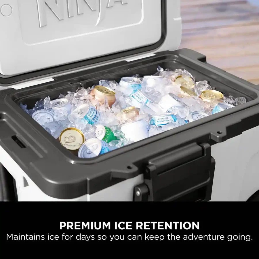 Ninja FrostVault white cooler open, filled with ice and assorted beverage cans inside.