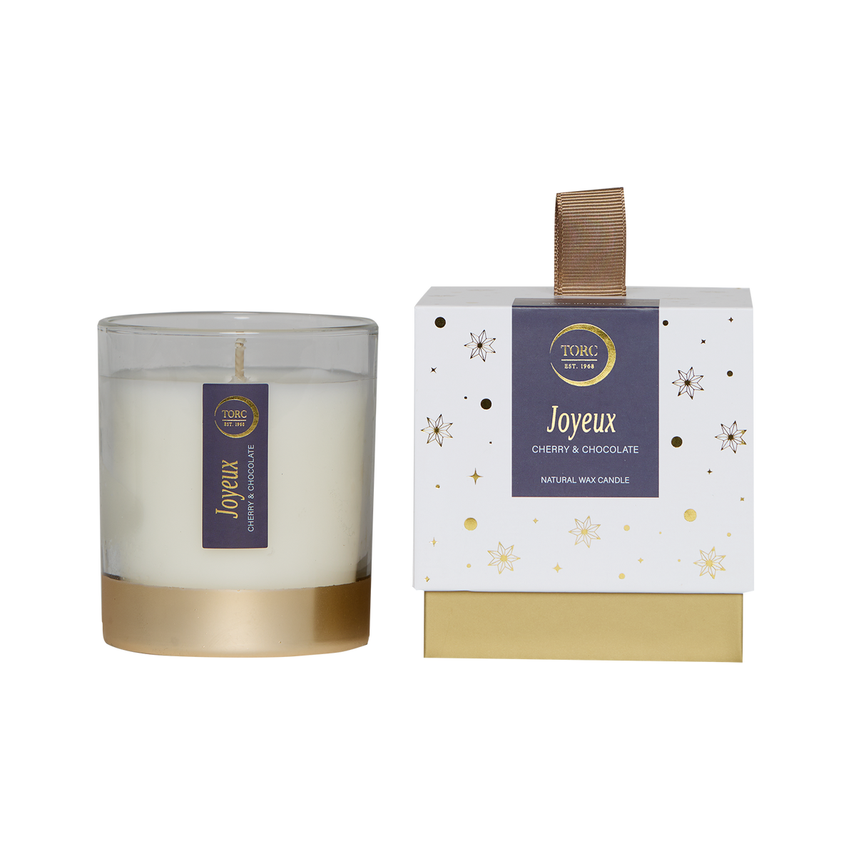 Torc Joyeux Christmas candle in glass with gold base beside white gift box with gold stars and ribbon