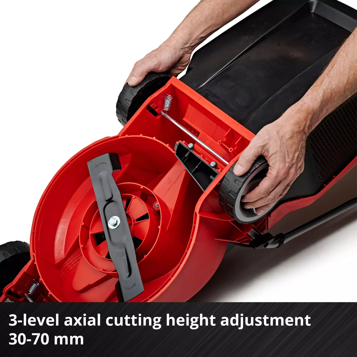 Hands adjusting the rear wheel on the underside of an Einhell 18V brushless lawnmower.