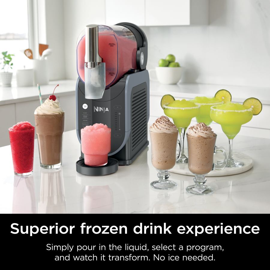 Ninja SLUSHi frozen drink maker dispensing pink slush with various frozen drinks on a kitchen counter.