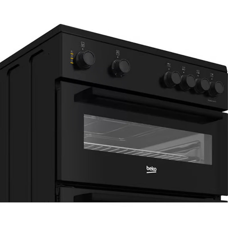 Beko 60cm twin cavity electric cooker in black, angled view showing control knobs and oven window