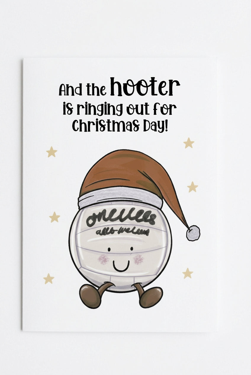 A square greeting card in clear plastic packaging, featuring a white background with the text 'And the hooter is ringing out for Christmas Day!' and a cartoon character wrapped in bandages wearing a Santa hat.