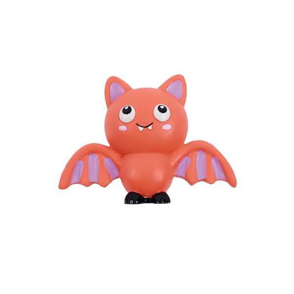 A cute cartoon bat toy or figurine in bright orange-red with light purple wings and inner ears, large white eyes, and small black feet, centered on a plain white background.
