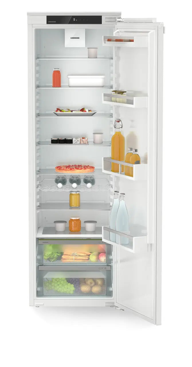 Liebherr IRE5100 integrated fridge with open door showing shelves stocked with drinks, food, and EasyFresh drawers.