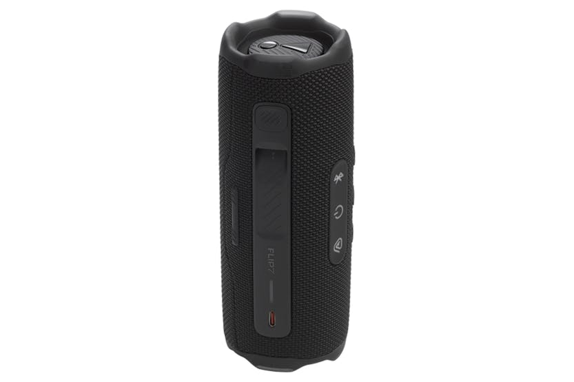 Black JBL Flip 7 portable Bluetooth speaker standing upright showing side controls and fabric texture.