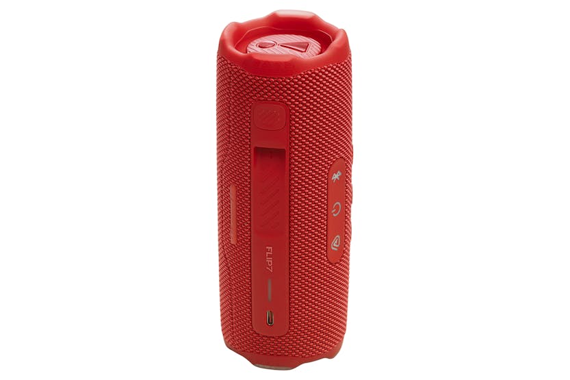 Red JBL Flip 7 portable Bluetooth speaker standing upright showing control buttons and charging port.