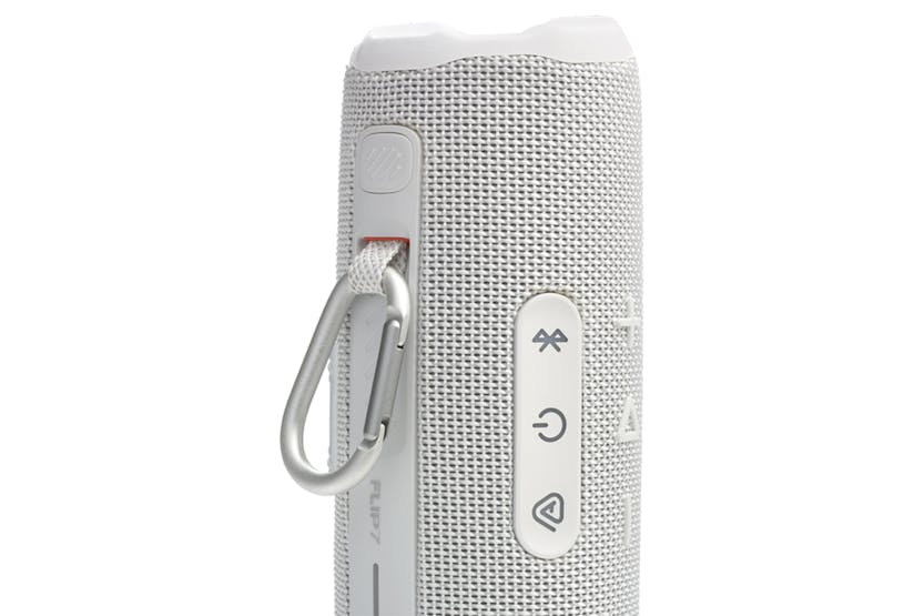 Close-up of the white JBL Flip 7 speaker side showing control buttons and attached silver carabiner clip.