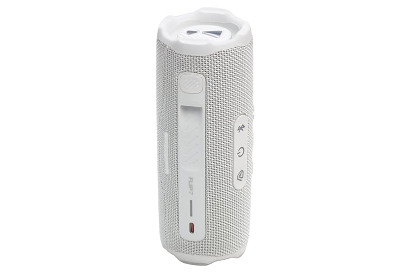 White JBL Flip 7 portable Bluetooth speaker standing upright showing control buttons and charging port.