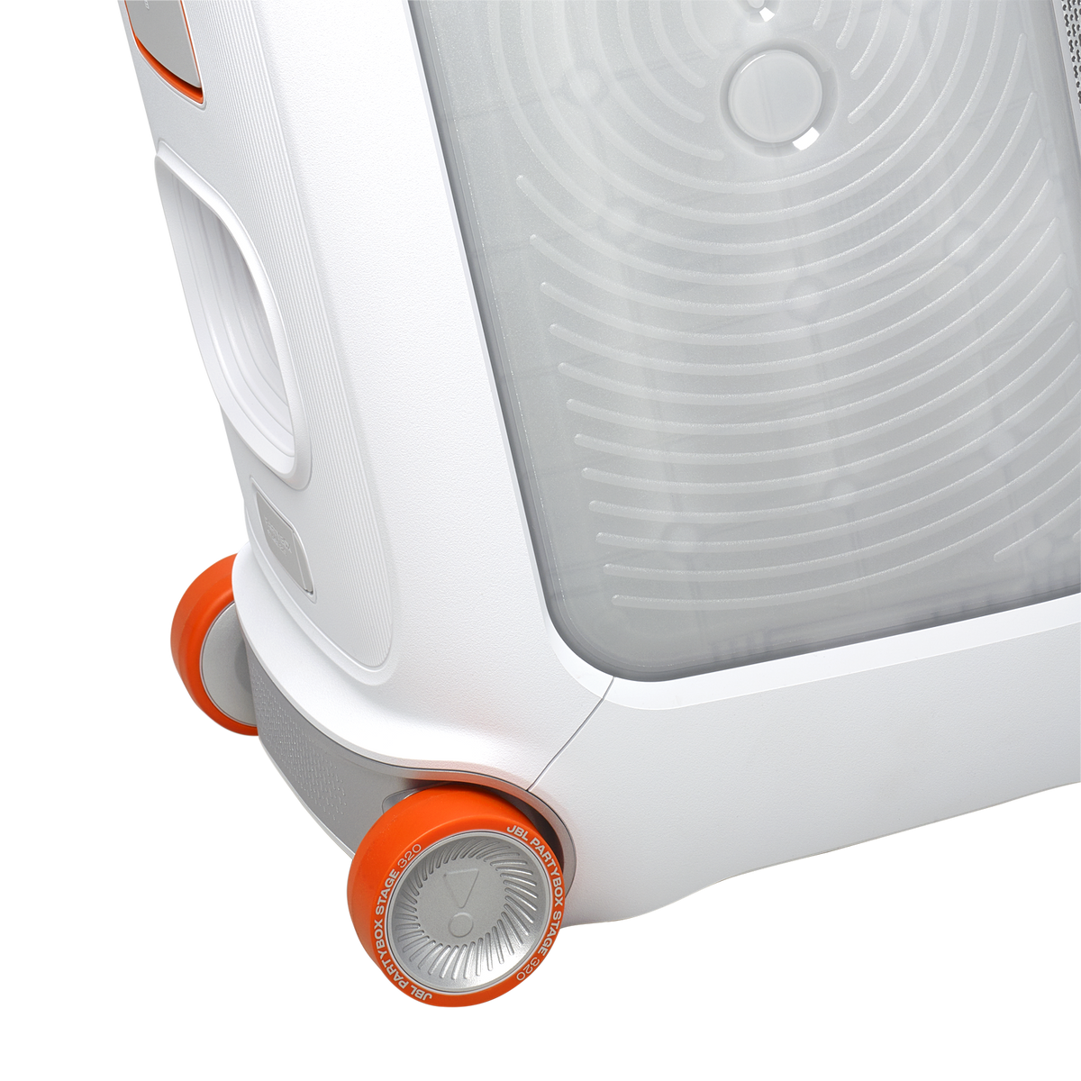 Close-up of the white JBL PartyBox Stage 320 speaker showing textured side, speaker grill, and orange wheels.