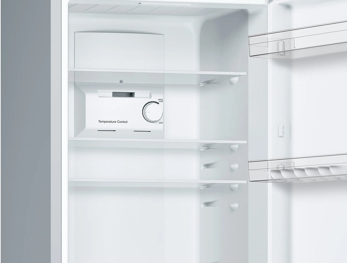 Interior close-up of Bosch Series 2 fridge freezer showing temperature control dial and glass shelves.