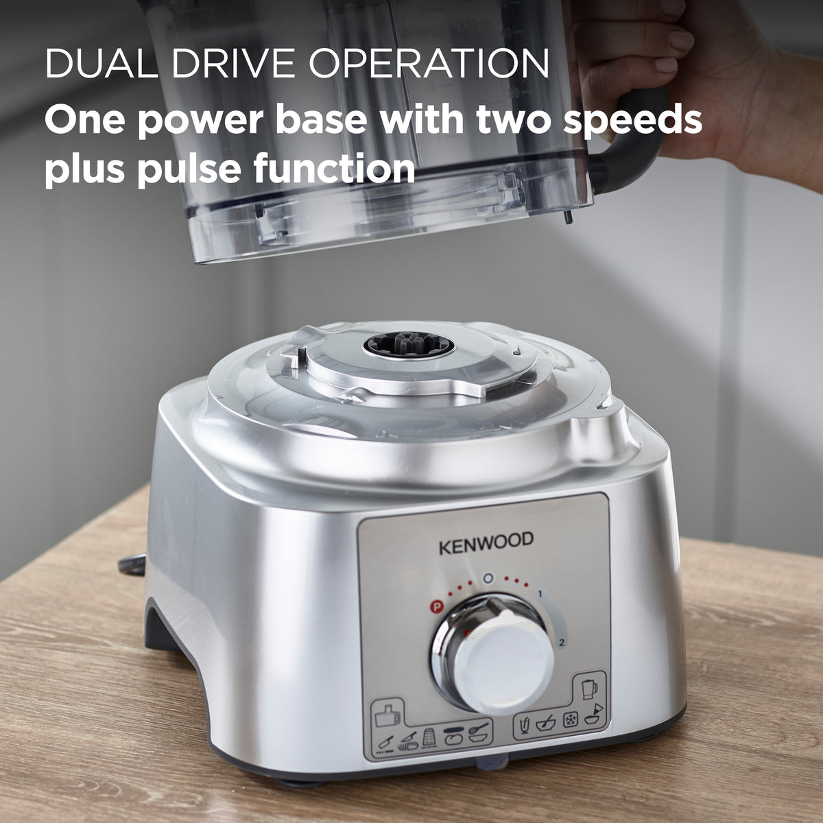 Kenwood MultiPro Express food processor base with control dial and attachment hub on wooden surface.